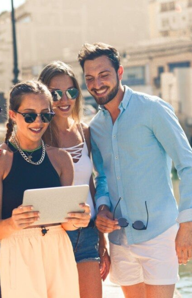 People smiling looking at a tablet